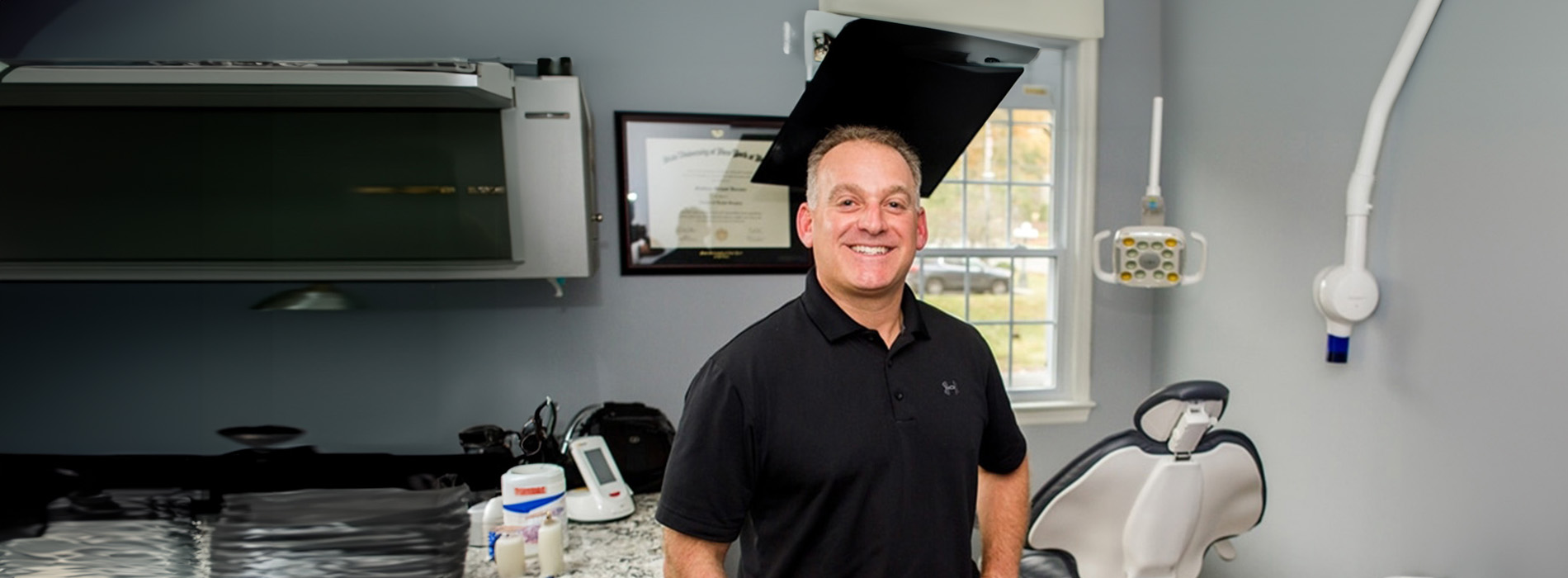 The image features a man standing in a kitchen, likely a professional setting given the stainless steel appliances and industrial style.